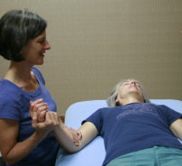 Marisha working with a client on the massage table